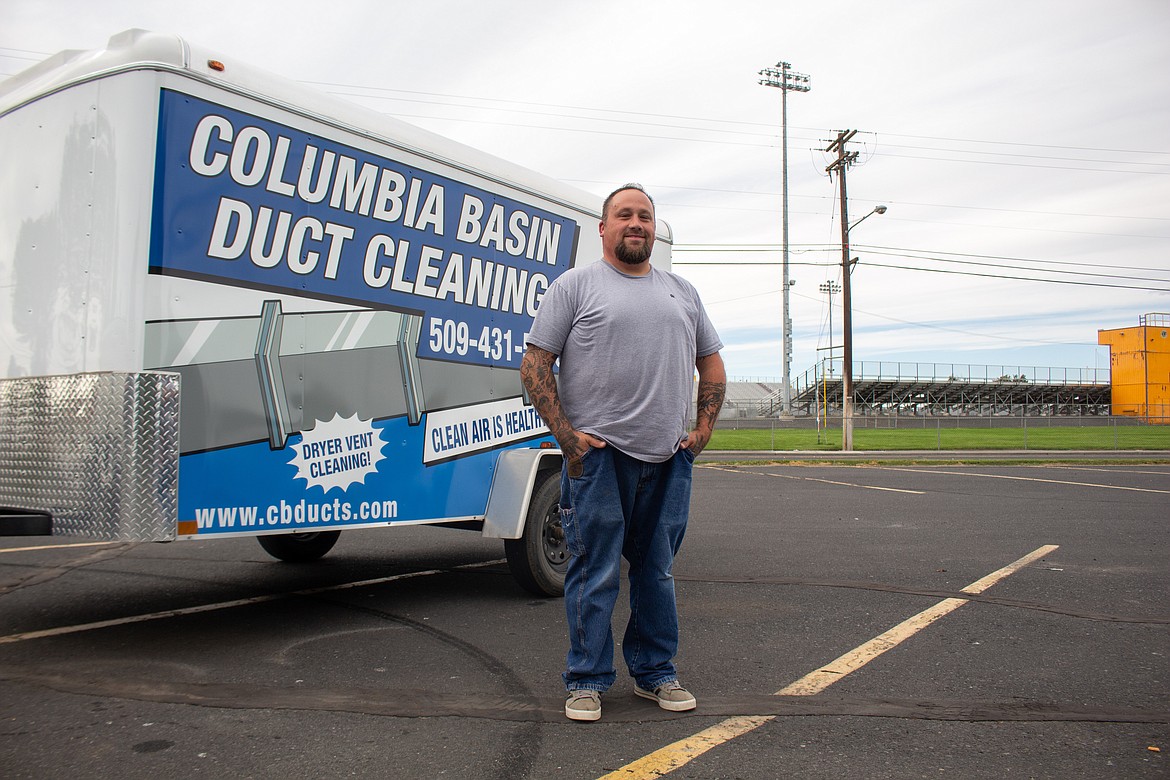 Jacob Miller, owner and operator of Columbia Basin Duct Cleaning, stands beside his work truck near McCosh Park in Moses Lake.