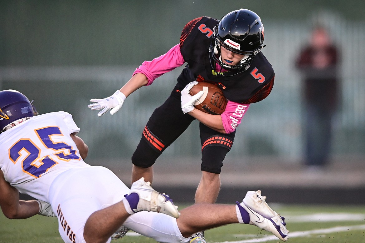 Flathead kick returner Dylan Kratofil (5) shakes a tackle by Missoula Sentinel defender Brandon Rondeau (25) on a return in the first quarter at Legends Stadium on Friday, Oct. 1. (Casey Kreider/Daily Inter Lake)