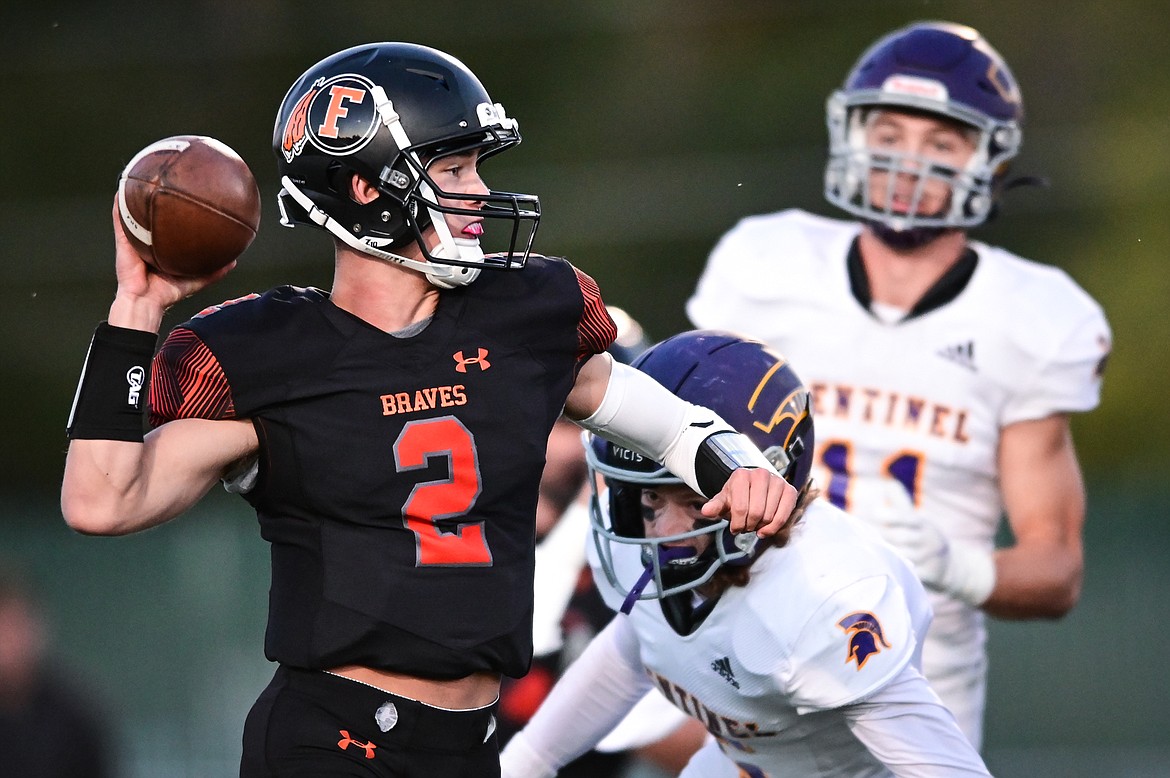 Flathead quarterback Jackson Walker (2) throws under pressure from Missoula Sentinel defenders in the first quarter at Legends Stadium on Friday, Oct. 1. (Casey Kreider/Daily Inter Lake)