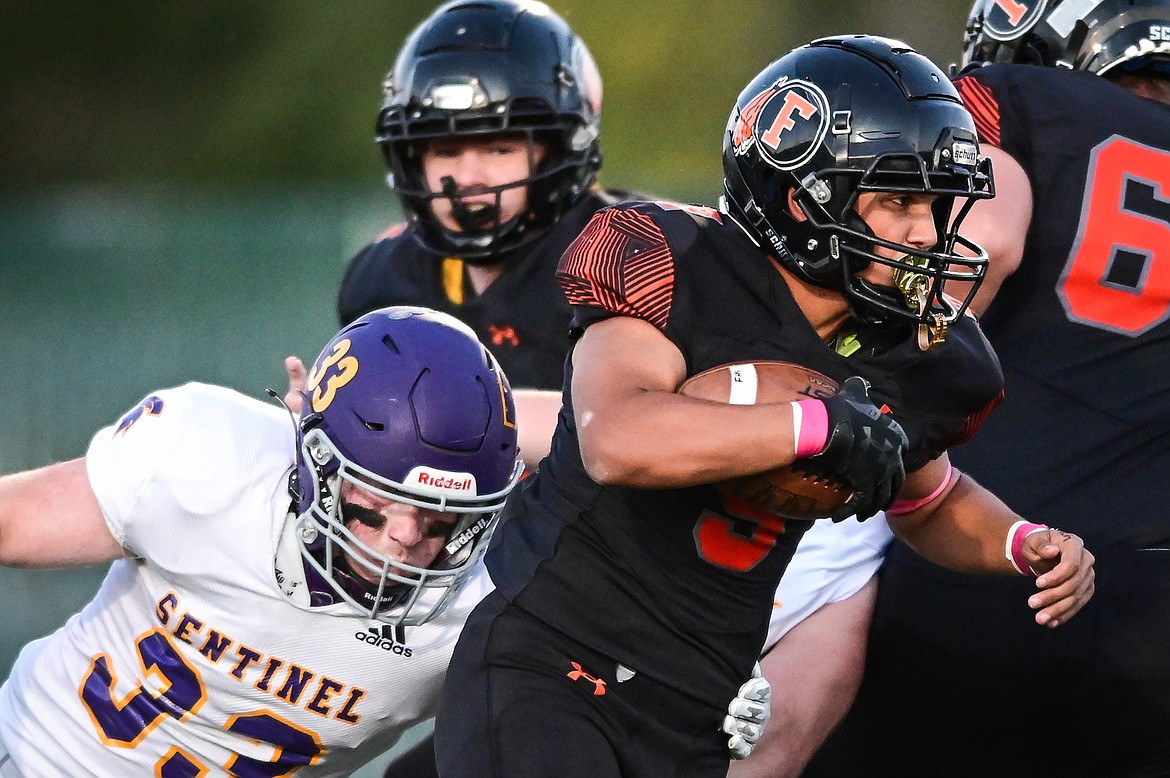 Flathead running back Joe Jones (9) looks for running room against the Missoula Sentinel defense in the first quarter at Legends Stadium on Friday, Oct. 1. (Casey Kreider/Daily Inter Lake)