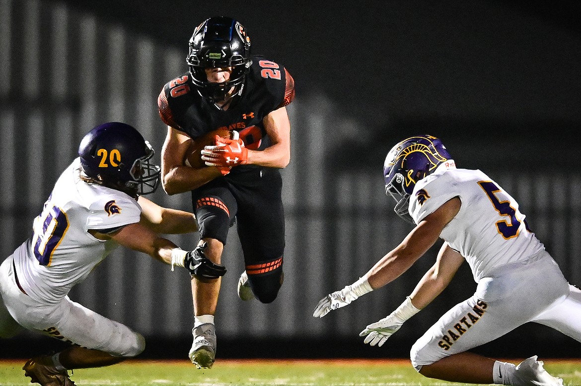 Flathead kick returner Trevor Burke (20) splits a pair of Missoula Sentinel defenders on a second quarter kick return at Legends Stadium on Friday, Oct. 1. (Casey Kreider/Daily Inter Lake)