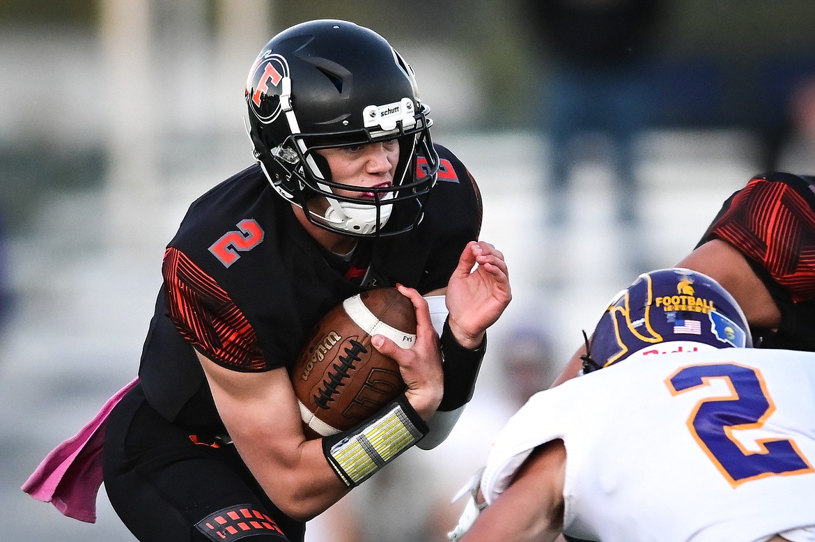 Flathead quarterback Jackson Walker (2) scrambles for a gain in the first quarter against Missoula Sentinel at Legends Stadium on Friday, Oct. 1. (Casey Kreider/Daily Inter Lake)