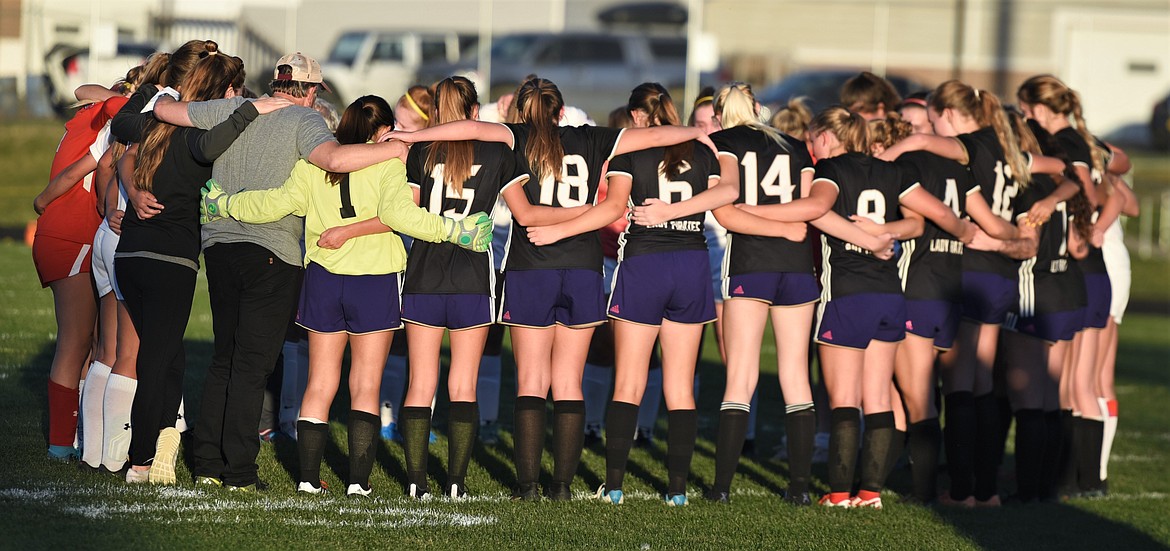 The Polson and Bigfork girls teams circled up together following Thursday's match. (Scot Heisel/Lake County Leader)