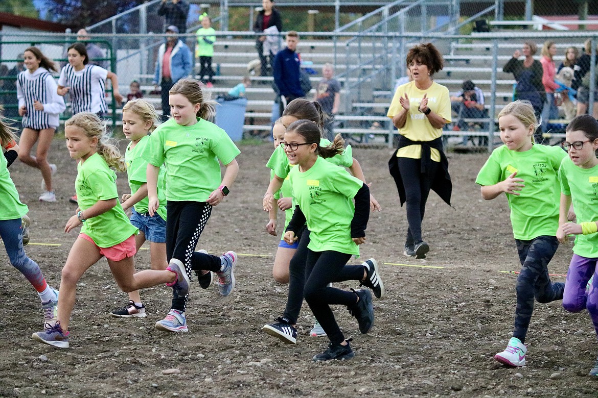 Second grade girls from the Coeur d'Alene School District take off at the cross-country run Thursday evening at the Kootenai County Fairgrounds. HANNAH NEFF/Press