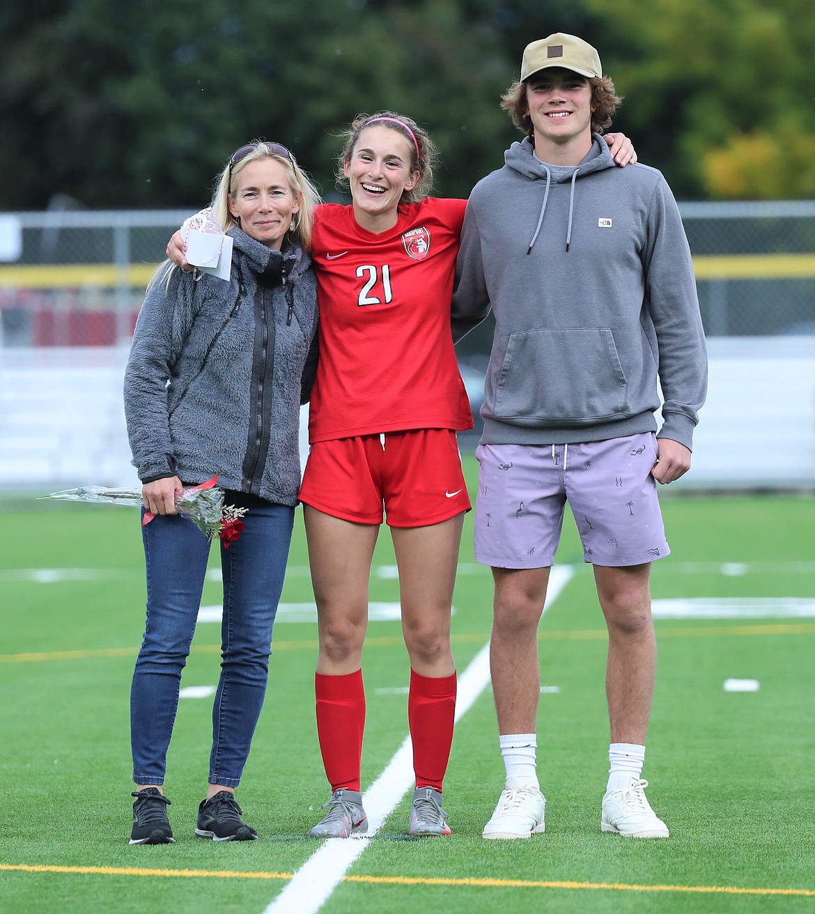 Piper Frank poses for a photo with her family on Senior Night.