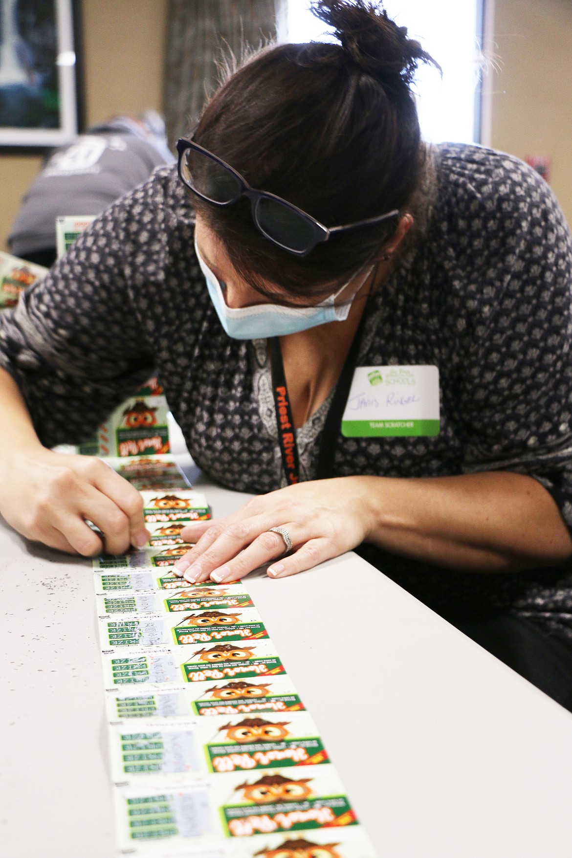 A West Bonner County teacher feverishly scratches away at lottery tickets during the annual Scratch for Schools event held by the Idaho Lottery on Thursday in Ponderay.