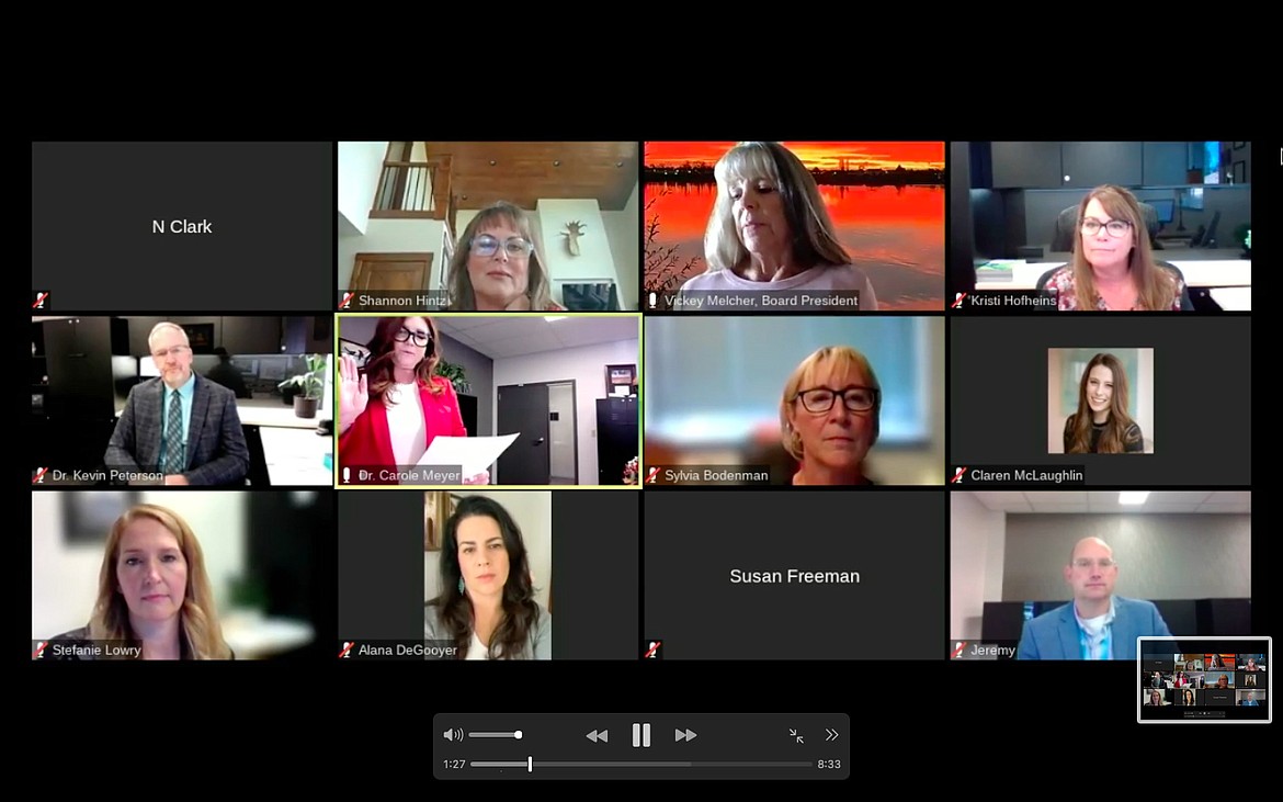 A screenshot shows the online-only meeting of the Moses Lake School Board swearing in assistant superintendent Carole Meyer, in center row second from the left, Thursday morning.