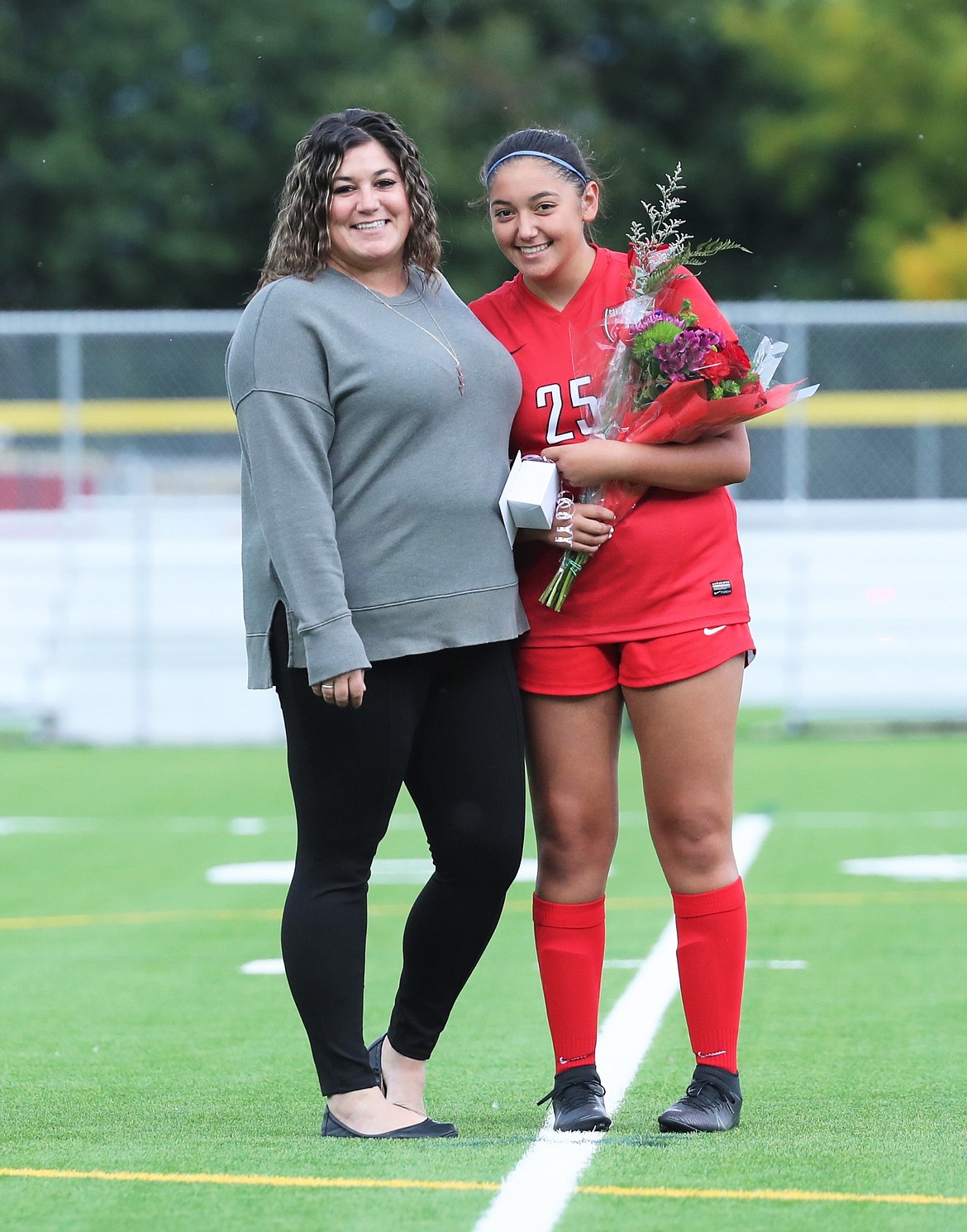 Teyler Hehn poses for a photo with her family on Senior Night.