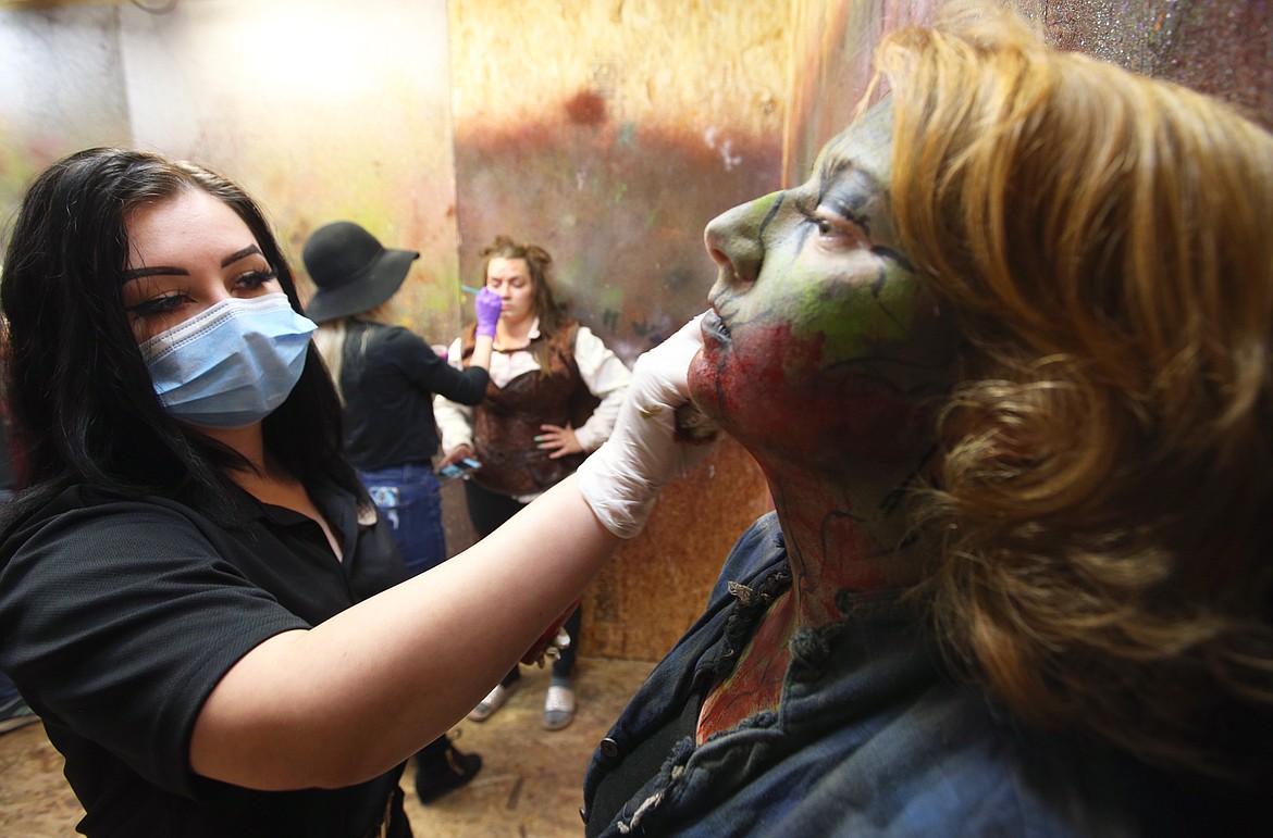 Jordan Ivey prepares Jessica Wolf for her zombie role at Scarywood Theme Park.
