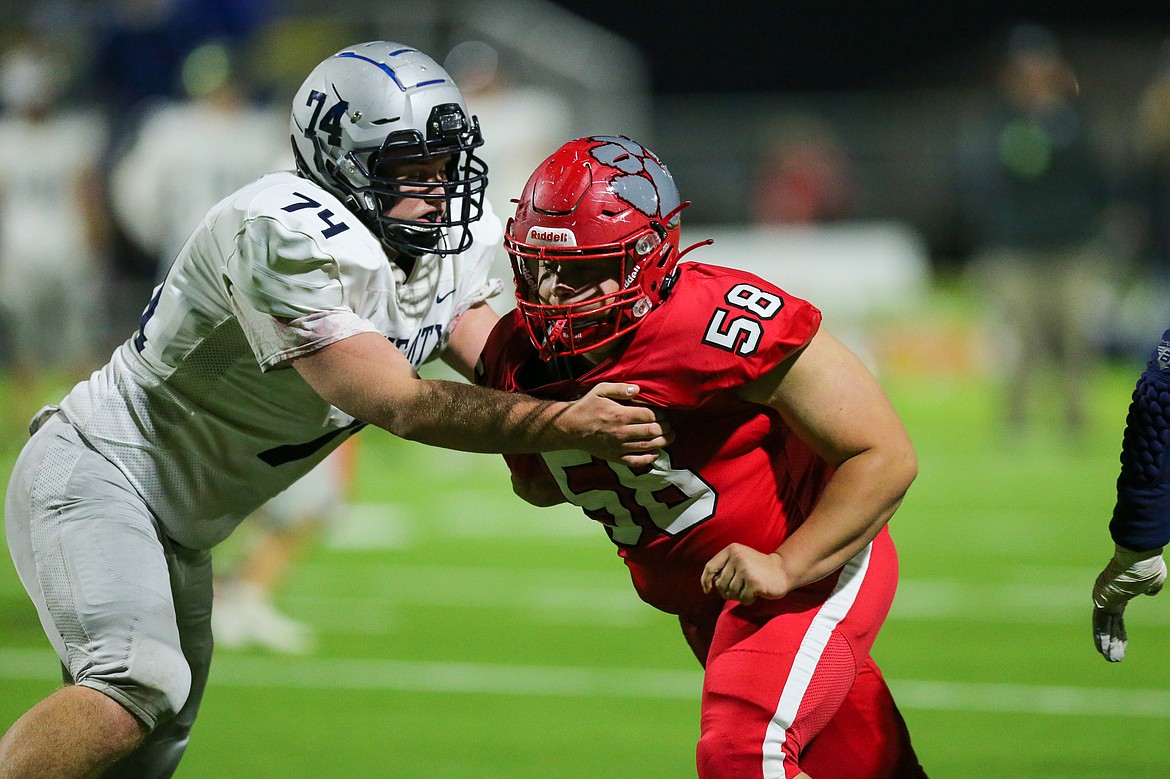 Defensive lineman Ryan McElroy tries to fight through a block during Friday's game against Lake City.