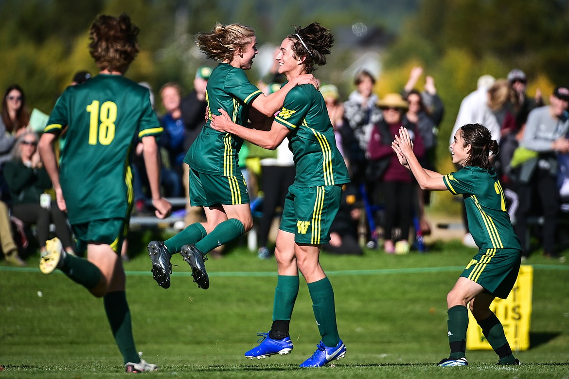 Whitefish's Chase Sabin (3) and Gabe Menicke (9) celebrate after Menicke's second goal in the first half against Columbia Falls at Smith Fields on Saturday. (Casey Kreider/Daily Inter Lake)