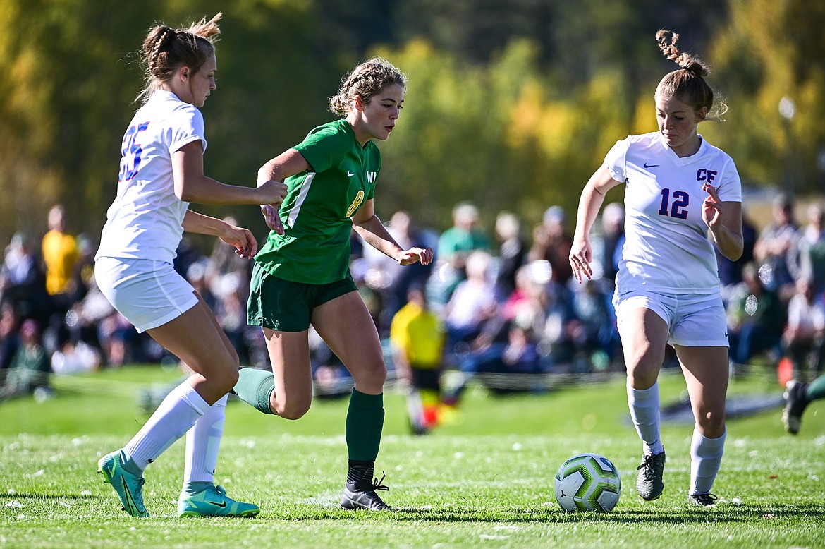 Whitefish's Brooke Roberts (8) splits Columbia Falls defenders Brenna Ruggiero (25) and Josie Harris (12) on her way to a first-half goal at Smith Fields on Saturday. (Casey Kreider/Daily Inter Lake)