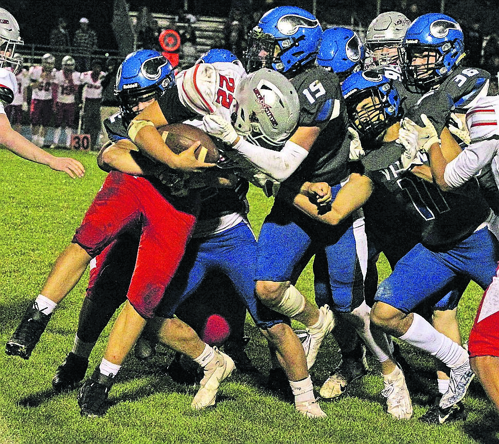 JASON ELLIOTT/Press 
Coeur d'Alene defenders Carsen Speelman (42), James Elliott (15), Mike Petree (11) and Joseph Cohen (36) bring down Ferris tailback Hunter Zigler during the third quarter of Friday's game at Viking Stadium.
