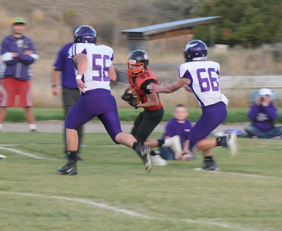 Plains football player Donny Nelson looks for room to run Saturday against Charlo. (Adam Lindsay/Valley Press)