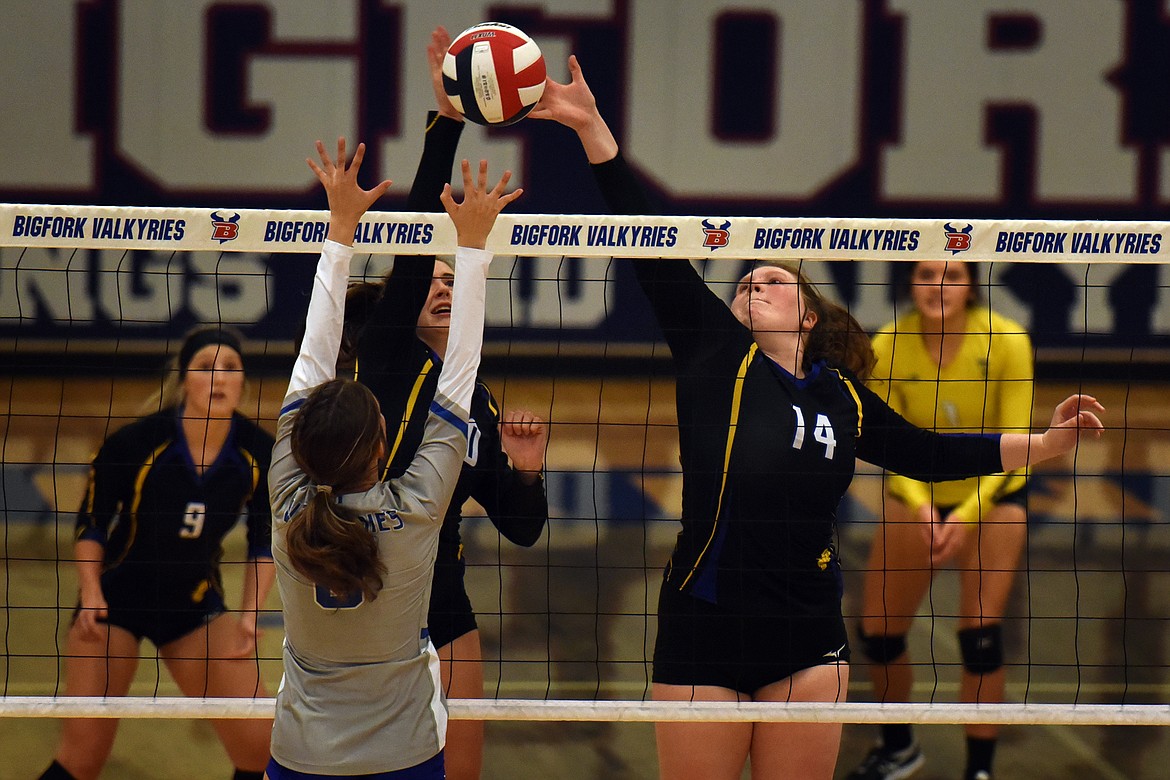 Thompson Falls' Abbigayle Lane tips the ball past Bigfork's Zoey Albert in the third set of their match last Saturday. The Lady Hawks beat the Valkryies in five sets. (Jeremy Weber/Valley Press)