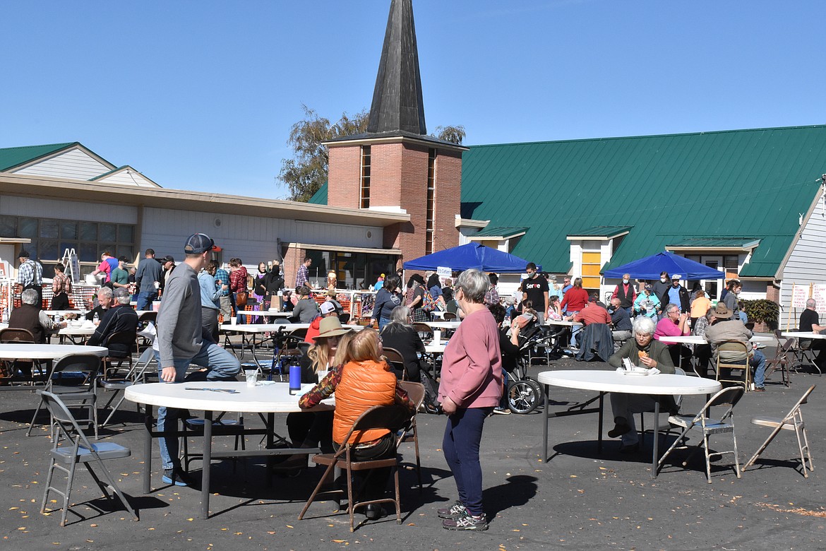 Dozens of tables were set up for attendees to mingle and enjoy food for sale, from sausage on a stick to ice cream, at the Mennonite Country Auction.