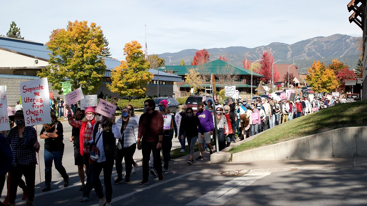 People hold signs as the walk along Baker Avenue in Whitefish during a reproductive rights rally on Saturday morning. In addition to Whitefish, National Women's March demonstrations were held in Billings, Great Falls, Helena, Missoula and Choteau, as well as over 600 cities across the U.S. (Photo provided)