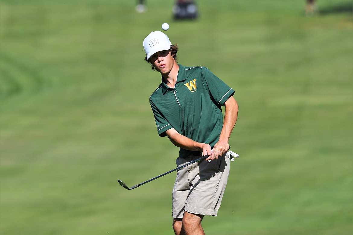 Bulldog Marcus Kilman watches his ball after taking a shot at the State A golf tournament in Polson. (Jeff Doorn photo)