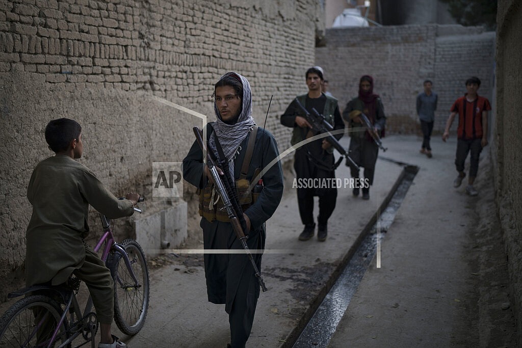 Taliban fighters patrol a neighborhood in search for a man accused in a stabbing incident, in Kabul, Afghanistan, Sunday, Sept. 12, 2021. The Taliban are promising a return of some of their harsh punishments that made them notorious. That has many Afghans afraid, but some also say they are giving the Taliban a chance if it means greater stability and fewer corrupt officials reaching into their pockets. (AP Photo/Felipe Dana)
