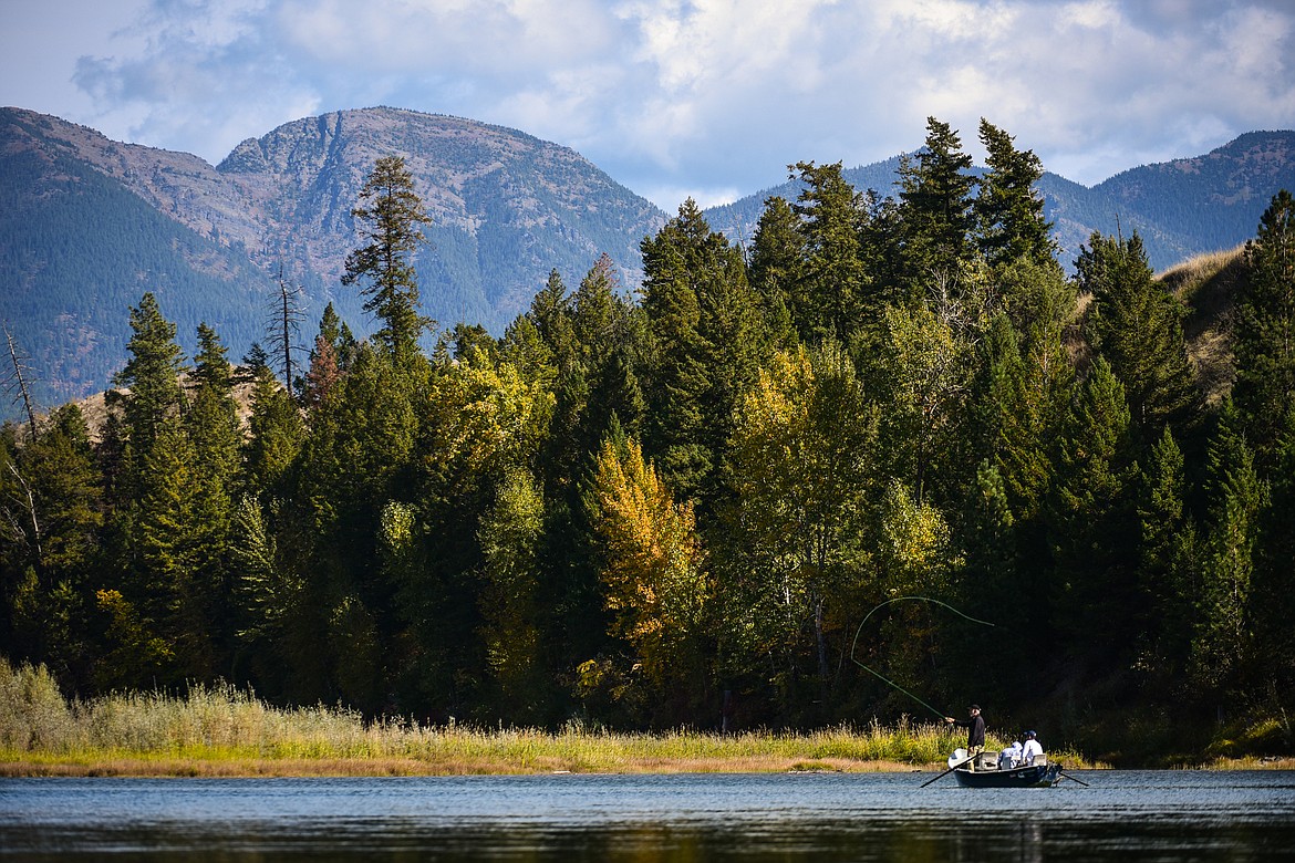 A fisherman in a boat casts a line into the Flathead River on Friday, Oct. 1. (Casey Kreider/Daily Inter Lake)