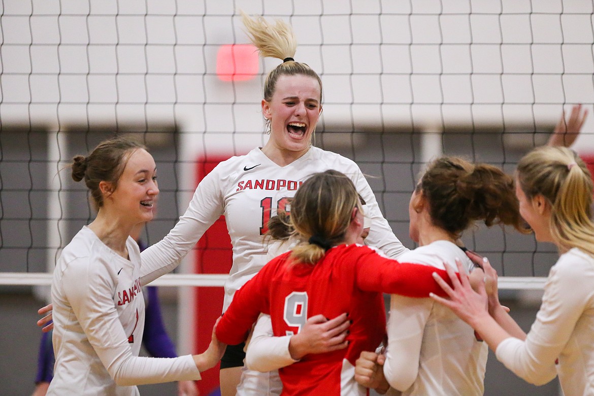 Senior Tori Pelkey celebrates with her teammates after the Bulldogs win a point during Tuesday's match.