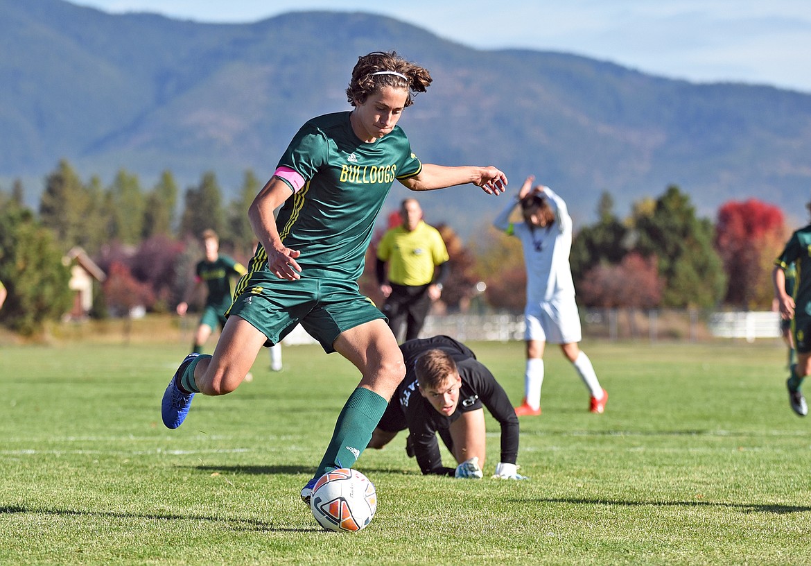 Bulldog Gabe Menicke makes a move to get around Wildcat goalkeeper Bryce Dunham for an open shot against Columbia Falls during a game in Whitefish on Saturday. (Whitney England/Whitefish Pilot)