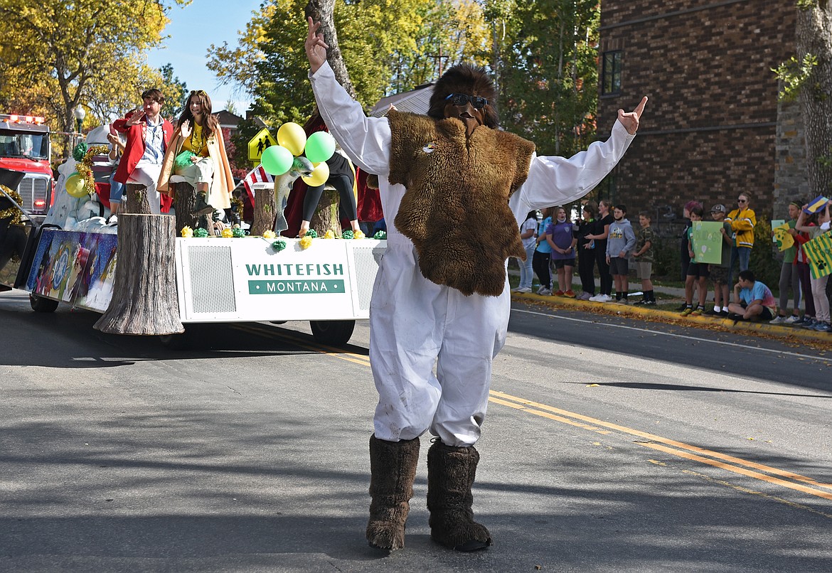 A Whitefish Winter Carnival Yeti poses for the crowd during the Whitefish High School Homecoming parade Friday afternoon. (Whitney England/Whitefish Pilot)