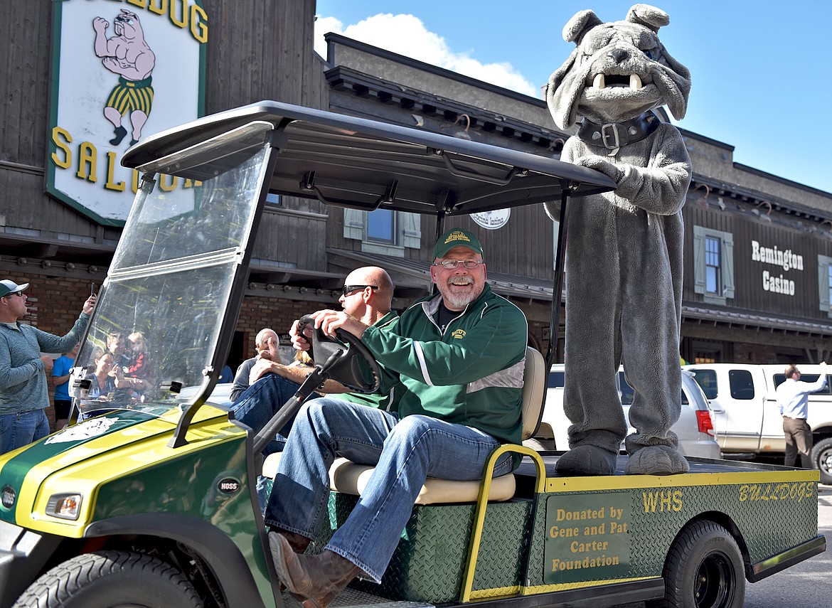 Whitefish High School principal Kerry Drown and assistant principal Jeff Peck drive along Central Avenue during the Whitefish High School Homecoming parade Friday afternoon. (Whitney England/Whitefish Pilot)