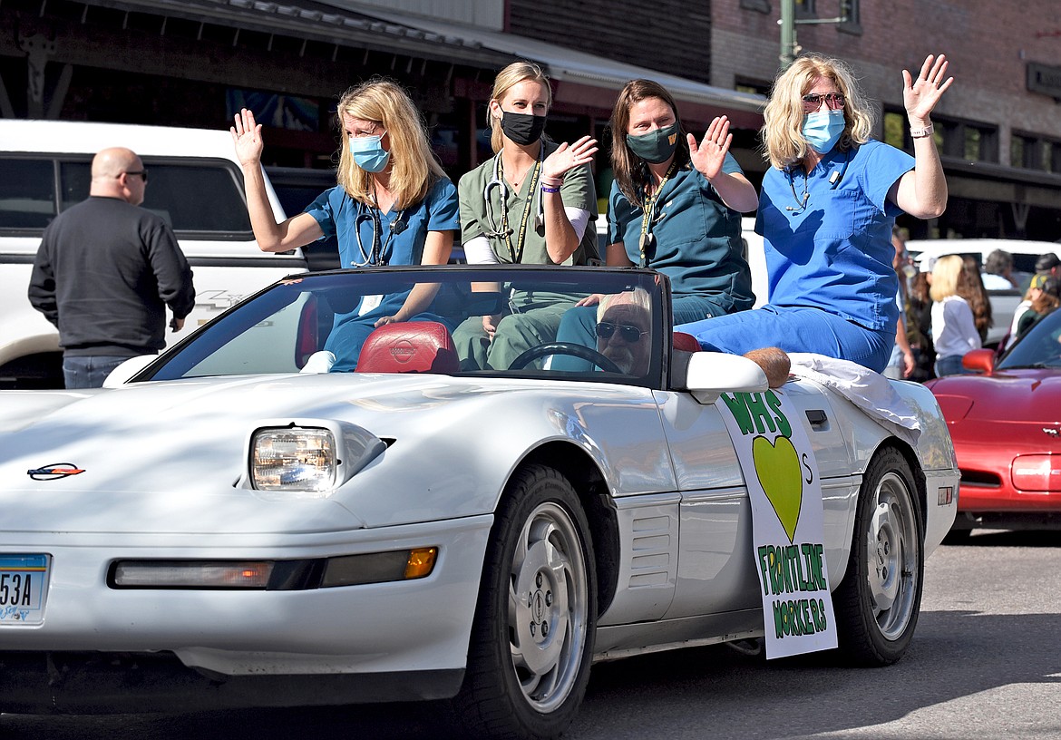 Local frontline healthcare workers ride in a convertible during the Whitefish High School Homecoming parade Friday afternoon. (Whitney England/Whitefish Pilot)
