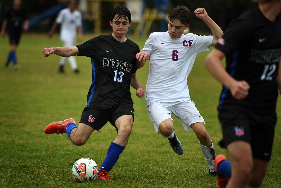 Viking Caleb Riedesel (13) holds off a Columbia Falls defender Tuesday. (Jeremy Weber/Bigfork Eagle)