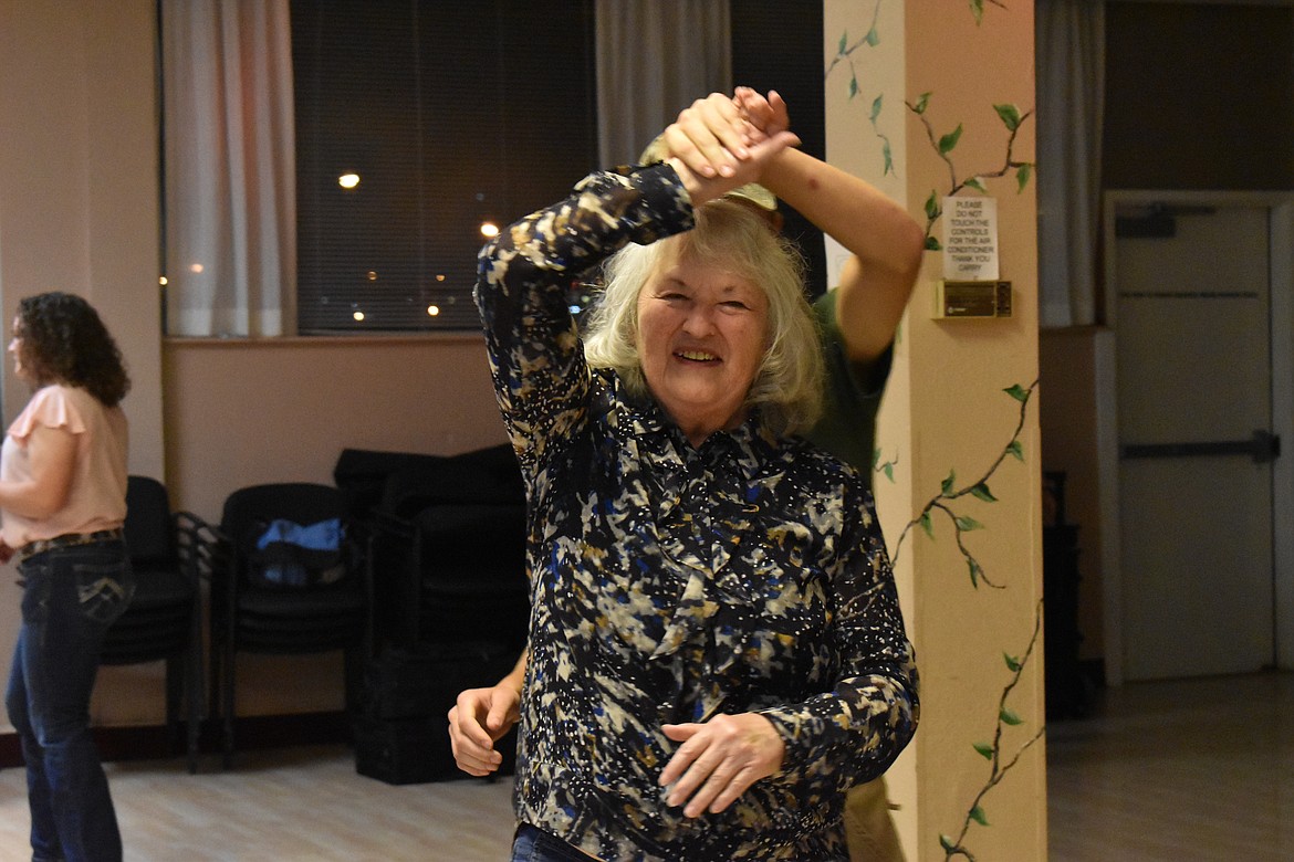 Muriel Hanson smiles as she is spun around by Jesse Humpherys.