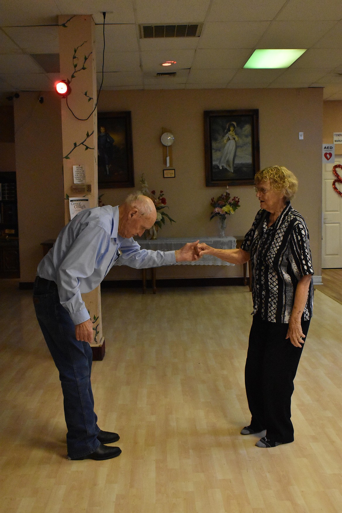 Harold Boyer, left, bows to Genie Wehling, right, after a dance together.