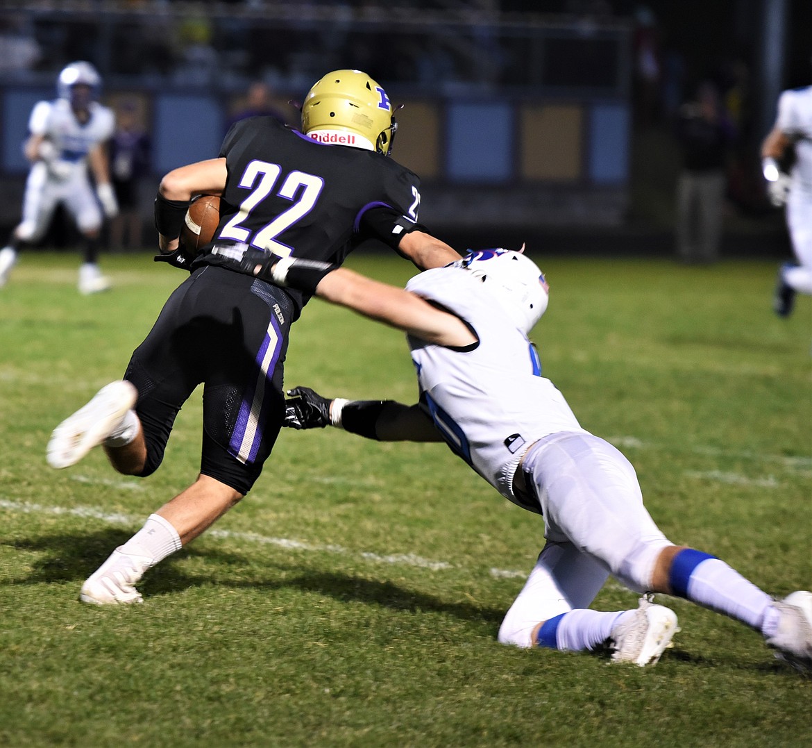 Junior running back Trent Dwelle breaks a tackle. (Scot Heisel/Lake County Leader)