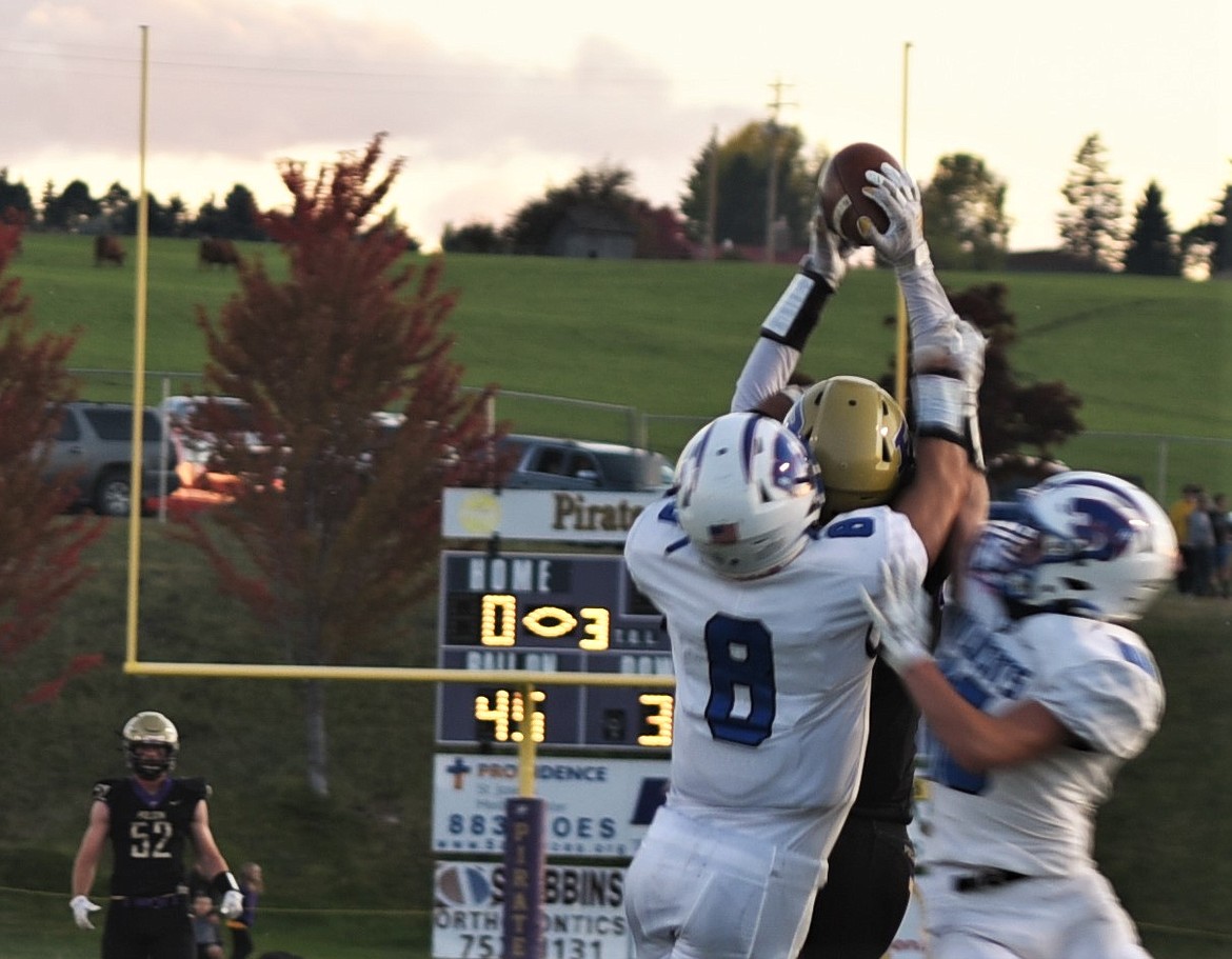 Polson receiver Colton Graham goes up for a catch with two Wildcats defenders wrapped around him in the first quarter. Graham came down with the reception. (Scot Heisel/Lake County Leader)