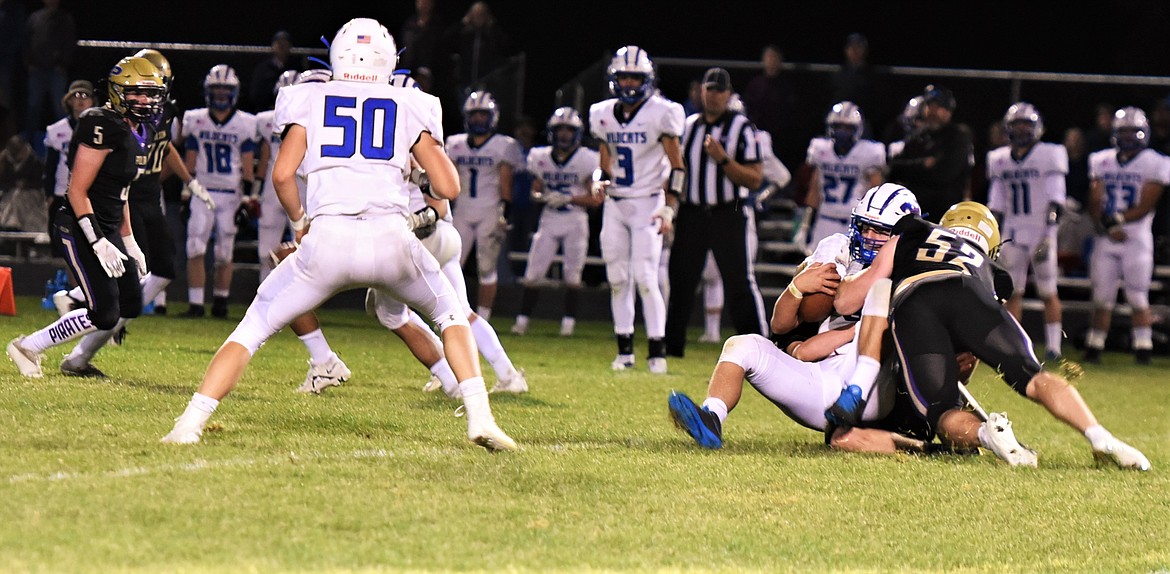 Polson defenders Braunson Henriksen (52) and Keyen Nash sack Wildcats quarterback Cody Schweikert. (Scot Heisel/Lake County Leader)