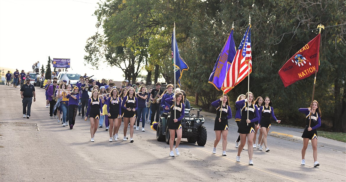 The Polson High School cheerleaders and band lead the way down Second Street during the school's homecoming parade Friday afternoon. (Scot Heisel/Lake County Leader)