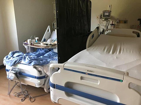 Due to climbing COVID-19 hospitalizations, normally one-person patient rooms house two beds that are split with a make-shift curtain. Photo courtesy Mary Rehnborg.