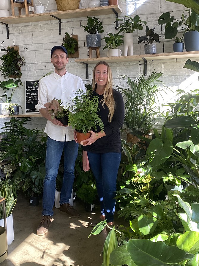 Owner Alex Ekins and plant specialist Sierra Davis blend in with the foliage at Fern Plant Shop on Lakeside Avenue.