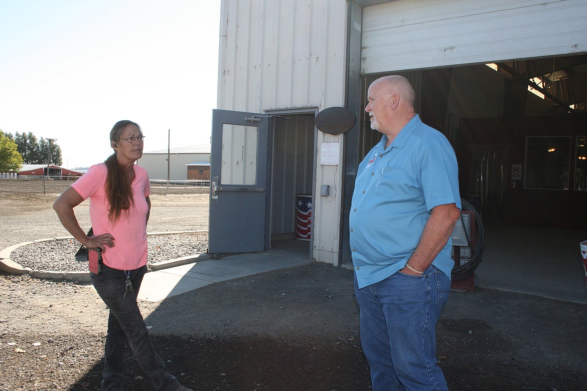 Allan Williams, right, events coordinator at the Grant County Fairgrounds, and fairgrounds employee Lori Halliday discuss where to look for a missing sponsor banner.