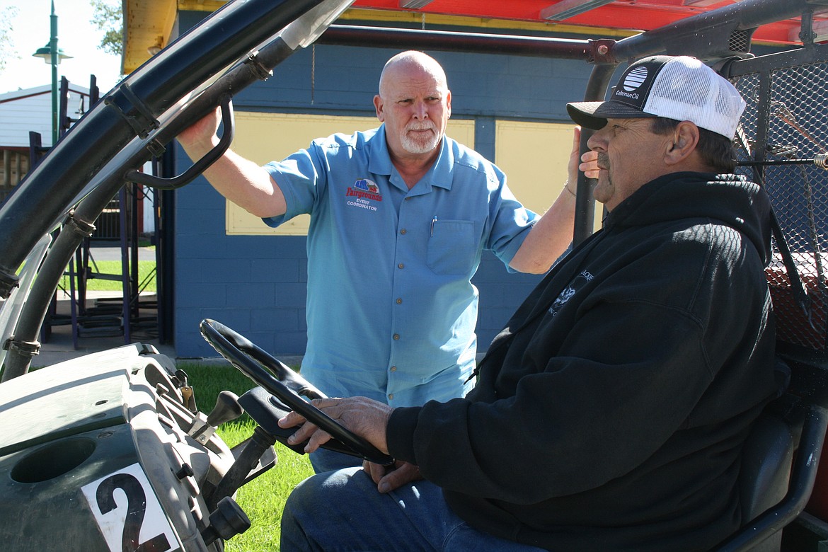 Allan Williams, left, events coordinator at the Grant County Fairgrounds, talks with fairgrounds employee Dennis Motzkus.