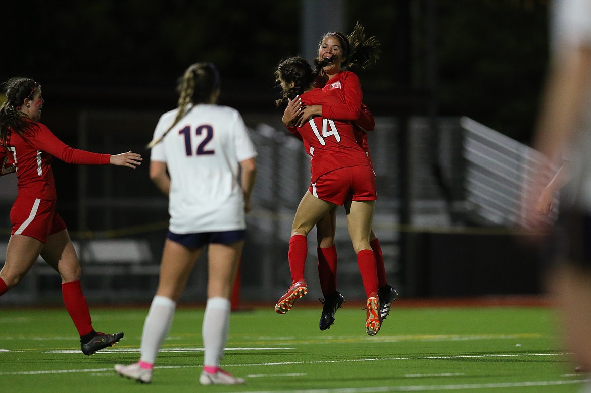 Hannah Harvey celebrates with Kailee McNamee after McNamee scores during the 73rd minute of Thursday's match.