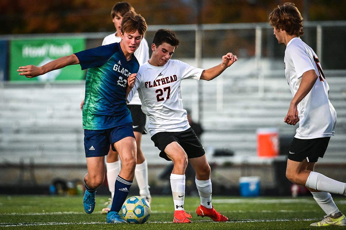 Glacier's Joey Paolini (23) pushes the ball into the Flathead zone against the Braves' Miller Bushnell (27) in the second half at Legends Stadium on Thursday, Oct. 7. (Casey Kreider/Daily Inter Lake)