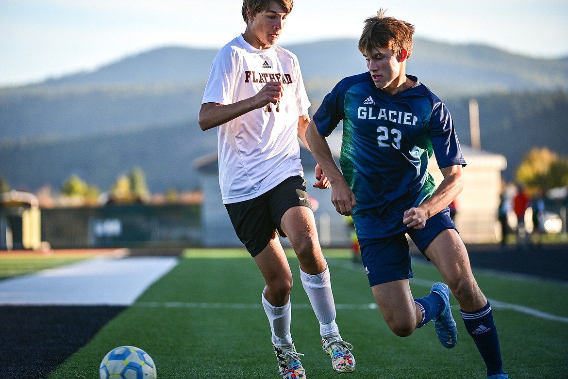 Glacier's Joey Paolini (23) pushes the ball past Flathead's Mason Molter (14) in the first half at Legends Stadium on Thursday, Oct. 7. (Casey Kreider/Daily Inter Lake)