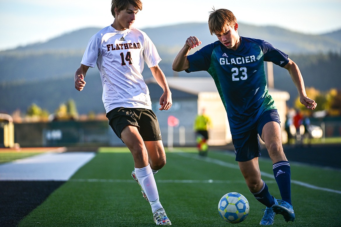 Glacier's Joey Paolini (23) pushes the ball past Flathead's Mason Molter (14) in the first half at Legends Stadium on Thursday, Oct. 7. (Casey Kreider/Daily Inter Lake)