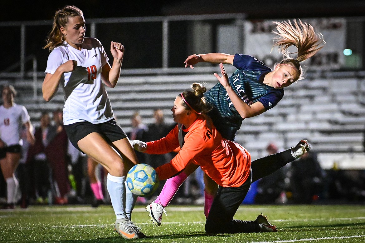 Glacier's Emmery Schmidt (21) and Flathead goalkeeper Sara Harrison (12) collide in the first half at Legends Stadium on Thursday, Oct. 7. (Casey Kreider/Daily Inter Lake)