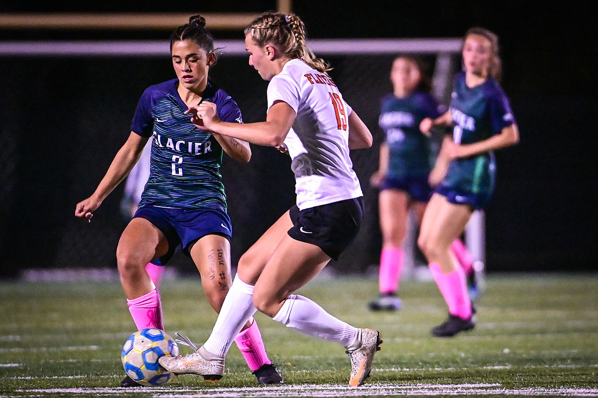 Glacier's Calista Wroble (2) pushes the ball upfield against Flathead's Alivia Rinehart (19) in the first half at Legends Stadium on Thursday, Oct. 7. (Casey Kreider/Daily Inter Lake)