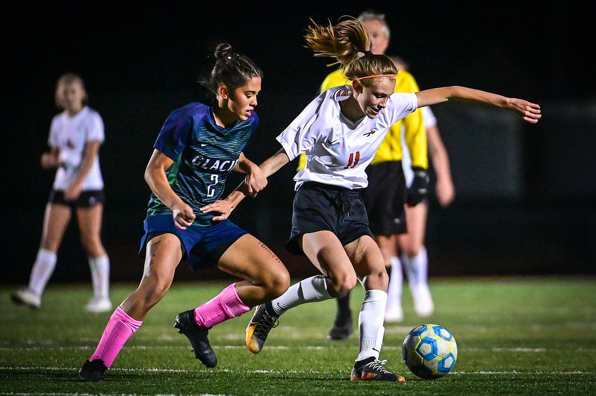 Flathead's Mia Stephan (11) battles for possession with Glacier's Calista Wroble (2) in the first half at Legends Stadium on Thursday, Oct. 7. (Casey Kreider/Daily Inter Lake)