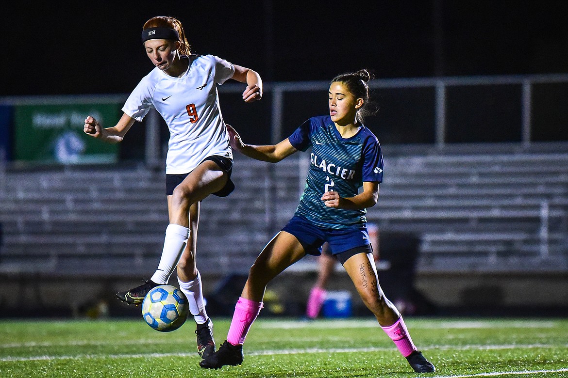 Flathead's Ally Pollan (9) plays the ball near midfield with Glacier's Calista Wroble (2) defending in the first half at Legends Stadium on Thursday, Oct. 7. (Casey Kreider/Daily Inter Lake)