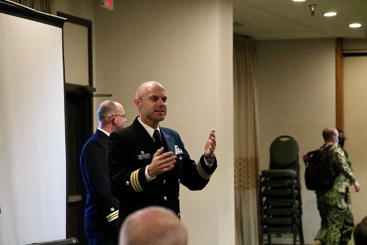 Cmdr. Nicholas Meyers, the commanding officer for USS IDAHO, speaks to a crowd of mostly retired Navy sailors at Red Lion Hotel Templin's on the River in Post Falls with four other crewmen for a meet and greet reception Wednesday night. HANNAH NEFF/Press