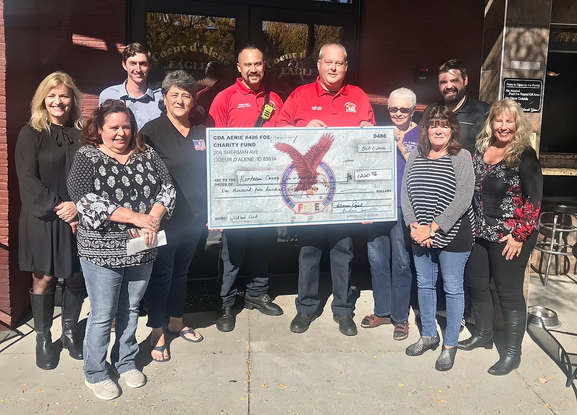 Eagle 486 presented the Kootenai County Fire and Rescue a check in the amount of $1,260 for its wildland fund. From left: Barb Smalley, auxiliary president; Eleanora Capaul, auxiliary secretary; Chris Gray, aerie trustee; Penny Wright, auxiliary treasurer; Battalion Chief Kaipo Kuehn; Chief Chris Way; Glenna Knepper, auxiliary inside guard; Debbie Magnuson, auxiliary trustee; Aerie President Dustin Oken and Bobbi Mesarchik, auxiliary member.